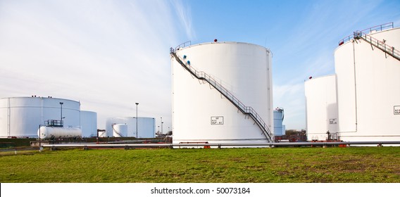 White Tanks For Petrol And Oil In Tank Farm With Blue Sky