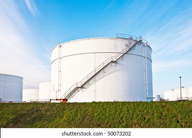 White Tanks For Petrol And Oil In Tank Farm With Blue Sky