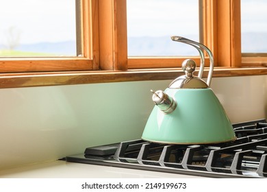 White Tea Kettle On A Gas Stove