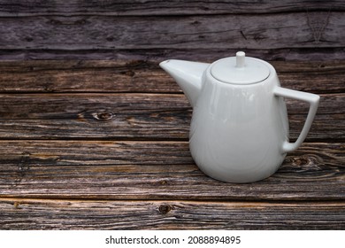 White tea pot ceramic wooden table, Vintage tone. Top view.