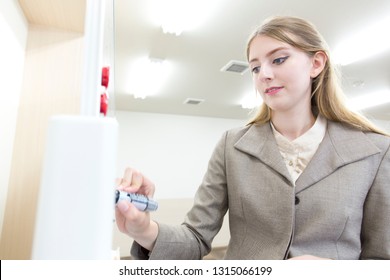 White teacher writing on the white board - Shutterstock ID 1315066199