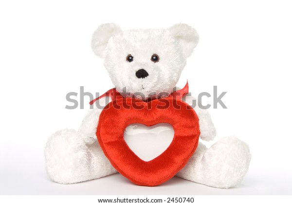 small teddy bear holding heart