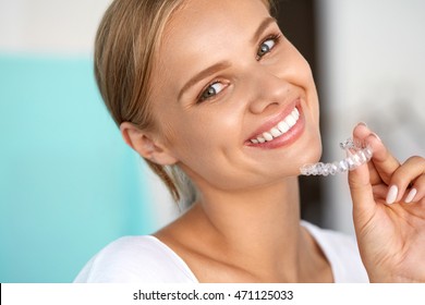White Teeth. Closeup Portrait Of Beautiful Happy Woman With Perfect White Smile Using Teeth Whitening Tray. Smiling Girl Holding Medical Invisible Braces. Dental Health Concept. High Resolution Image - Shutterstock ID 471125033