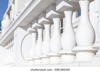 White terrace balusters made of painted concrete. Abstract classical architecture exterior fragment