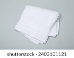 White terry towel on light grey background, top view