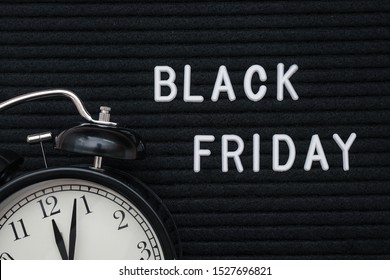 White text Black friday on black letter board and alarm clock, closeup. Concept Black friday , season sales time. Flat lay Top view Copy space Template layout for your design.