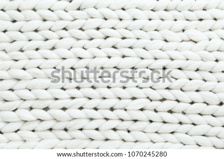 White texture background from merino knitted blanket, scandinavian minimalism backdrop with copy space, top view