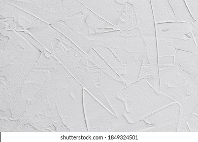 white textured background of filler paste applied with putty knife in irregular dashes and strokes