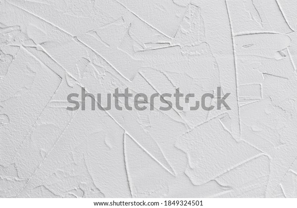 white textured background of\
filler paste applied with putty knife in irregular dashes and\
strokes
