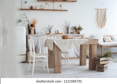 White Textured Kitchen In The Style Of Shabby. A Large Table In An Ecological Style And Loft Style. Rustic Shelves, Napkins, Old Refrigerator, Diy