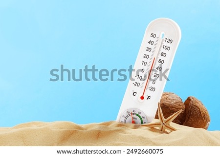 White Thermometer Measuring High Temperature on Sandy Beach With Starfish