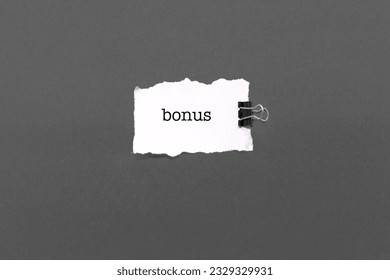 White thorn paper with the word BONUS on grey background - Shutterstock ID 2329329931