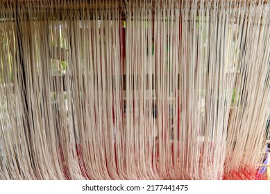 White Thread Texture Background. Stretched Yarn Being Prepped For Making Clothing, Sewing Equipment, Loom Equipment At A Garment Factory.