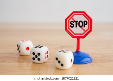 White Three Casino Dice Gambling And Warning Stop Sign On Wooden Background With Copy Space. Gambling, Betting Online Casino Warning, Social Problem Concept.