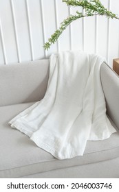 White Throw Blanket On A Sofa