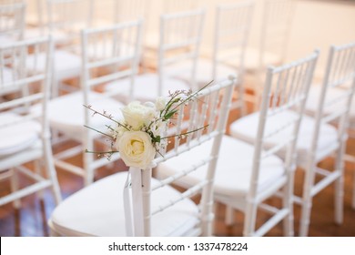 White Tiffany Chairs Set Up For Ceremony With White Rose Posts On The End Chair On Aisle