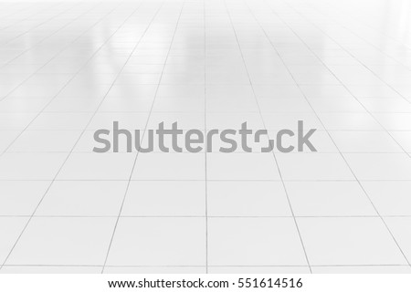White tile floor background in perspective view. Clean surface and symmetry with grid line texture or pattern. For decoration in bathroom, kitchen and laundry room.