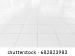 White tile floor clean and symmetry with grid line texture in perspective view for background. Flooring permanent covering by tile, Square shape of white tile made from ceramic material covering floor