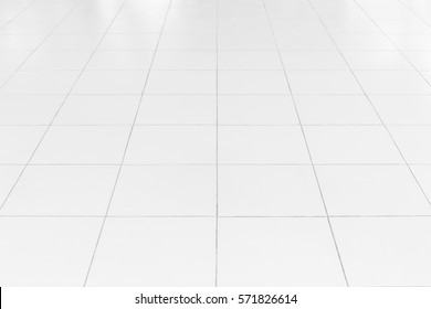 White tile floor clean and symmetry with grid line texture in perspective view for background. Flooring permanent covering by tile, Square shape of white tile made from ceramic material covering floor - Shutterstock ID 571826614