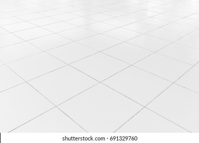 White tile floor clean and symmetry with grid line texture in perspective view for background. Flooring permanent covering by tile, Square shape of white tile made from ceramic material covering floor - Shutterstock ID 691329760