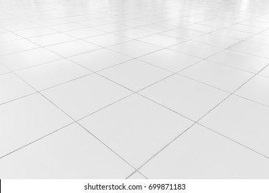 White Tile Floor Clean And Symmetry With Grid Line Texture In Perspective View For Background. Flooring Permanent Covering By Tile, Square Shape Of White Tile Made From Ceramic Material Covering Floor