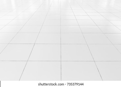 White tile floor clean and symmetry with grid line texture in perspective view for background. Flooring permanent covering by tile, Square shape of white tile made from ceramic material covering floor - Shutterstock ID 735379144