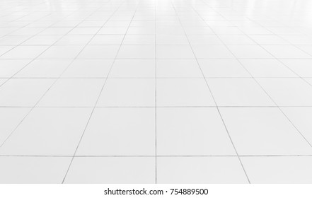 White tile floor clean and symmetry with grid line texture in perspective view for background. Flooring permanent covering by tile, Square shape of white tile made from ceramic material covering floor - Shutterstock ID 754889500