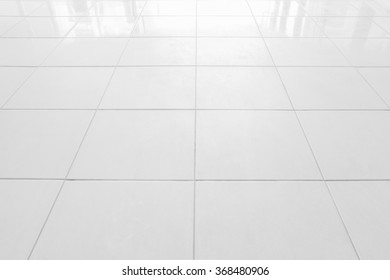 White Tile Floor In Office.White Tiles Floor For Bedroom , Kitchen, Bathroom And Interior Design.White Tiles Floor In Perspective View. Clean And Symmetrical Surface With Grid Texture Background.