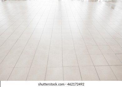 White Tile Floor In Office.White Tiles Floor For Bedroom , Kitchen, Bathroom And Interior Design.White Tiles Floor In Perspective View. Clean And Symmetrical Surface With Grid Texture Background.