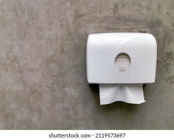 White Tissue Dispenser Box Hang On Raw Concrete Wall Background.