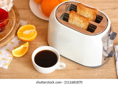 White Toaster With Tasty Breakfast On Counter In Kitchen