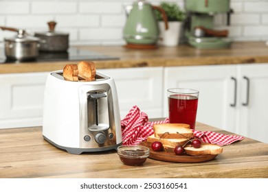 White toaster and wooden plate with bread slices on table in kitchen - Powered by Shutterstock