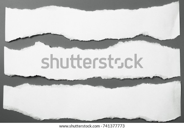white\
torn paper on gray background. collection paper\
rip