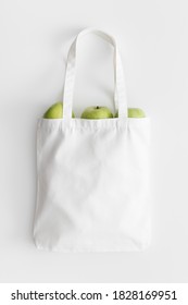 White Tote Bag Mockup With Apples On A White Table.