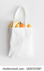 White Tote Bag Mockup With Fruit On A White Table.