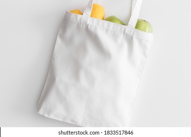 White Tote Bag Mockup With Fruit On A White Table.