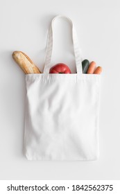 White Tote Bag Mockup With Groceries On A White Table.