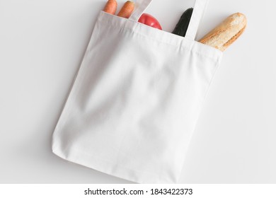 White Tote Bag Mockup With Groceries On A White Table.