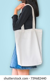 White Tote Bag Mockup Template Cotton Canvas Fabric Texture On Girl Shoulde On Blue Background