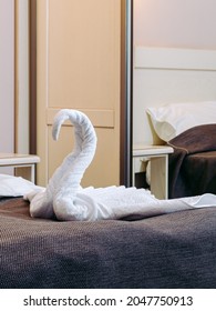 White Towels Are Folded In A Swan Shape On The Hotel Bed. Origami - Towel Swan.