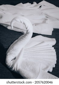 White Towels Are Folded In A Swan Shape On The Hotel Bed. Origami - Towel Swan.