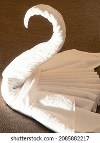 White Towels Are Folded In A Swan Shape On The Hotel Bed, Close-up. Origami - Towel Swan.