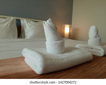 White towels on a white bed in the bedroom. Relax.