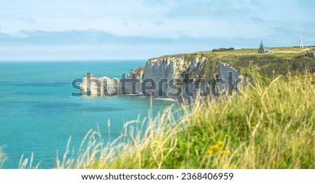 white towering sea cliff in the distance in Étretat