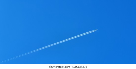 The White Trail Of The Plane In The Blue Sky