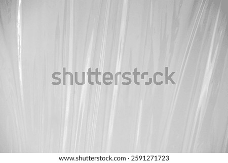 white or translucent plastic sheet with visible creases and folds. the transparent plastic wrap for design overlay