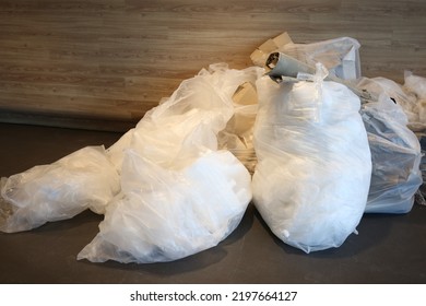 White Trash Bag In Office. Recycling Dirty Thing In City As Waste Ready In White Big Garbage Bag. Waste Sorting For Climate Changing.