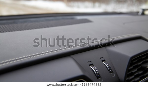 white trim on the\
black leather interior of a premium modern car. close-up. selective\
focus. no people
