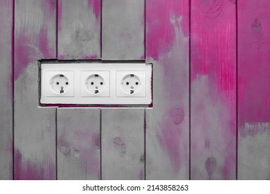 White Triple Power Socket Electric Outlet Plug Voltage On Wooden Painted Decorative Color Boards Modern Interior.