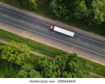 White Truck With Cargo Semi Trailer Moving On Summer Road. Aerial Top View